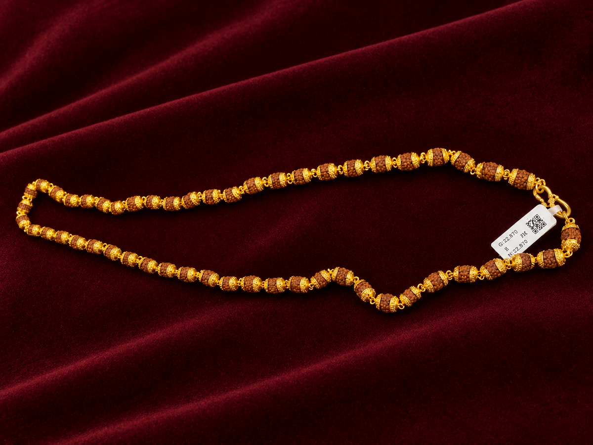 Rudraksha mala chain with 22kt gold caps on deep red velvet background