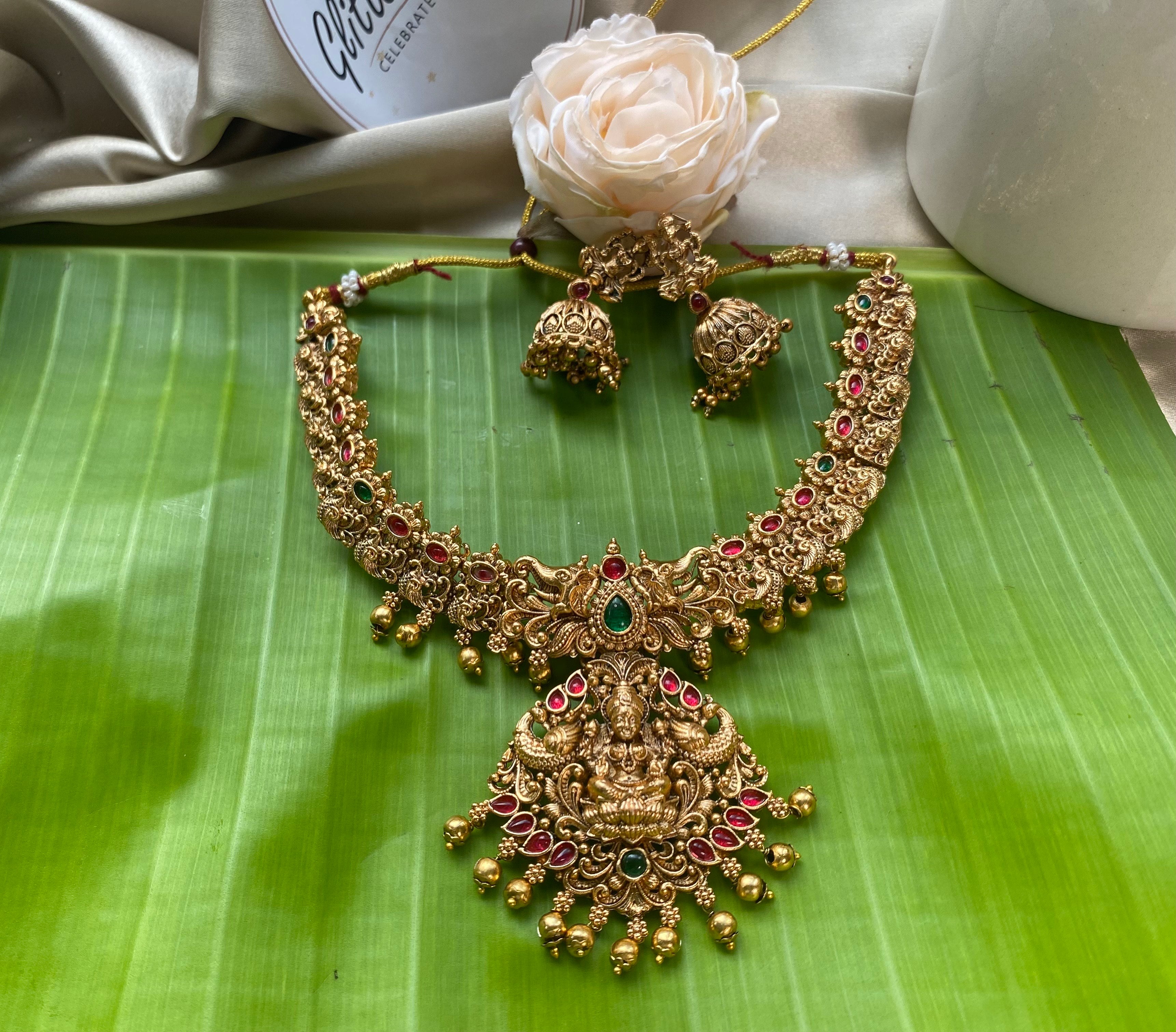 Antique temple-inspired design with goddess motifs - red and green stones 