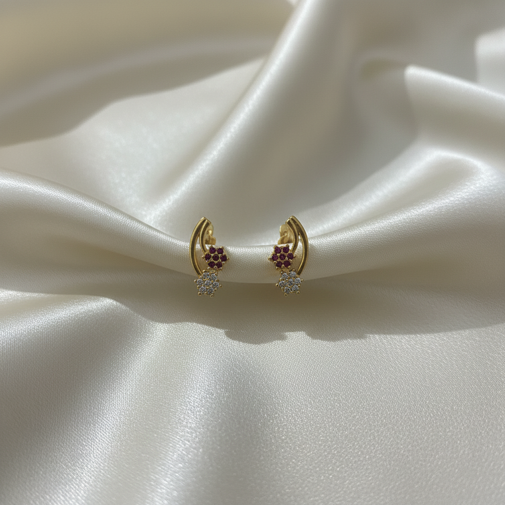 Gold crescent moon earrings on satin fabric